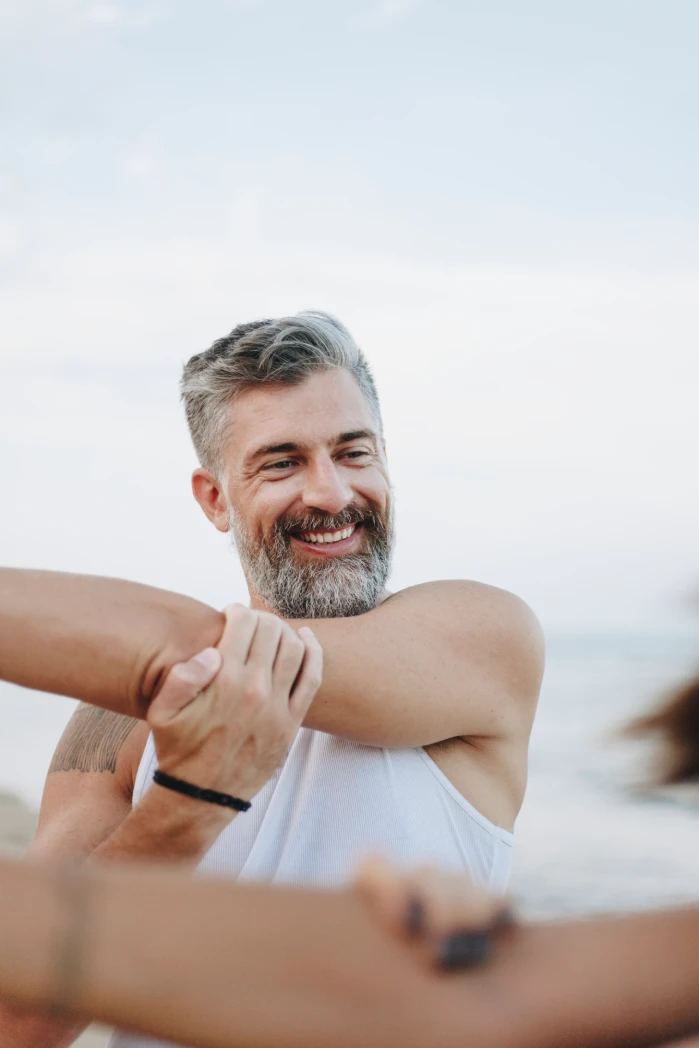 Couple stretching at the beach